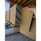 Rockslide transferring drywall from a boom fork through a doorway